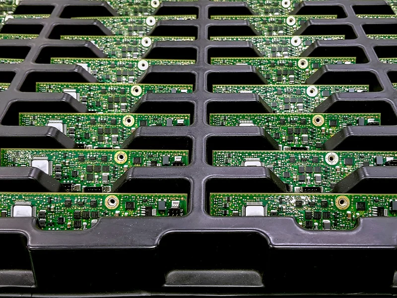 Black tray for circuit boards, manufactured from masterbatch.