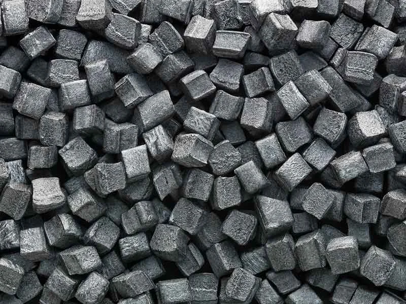 Dark grey cube-shaped PIB granulate, manufactured in a BUSS compounding plant