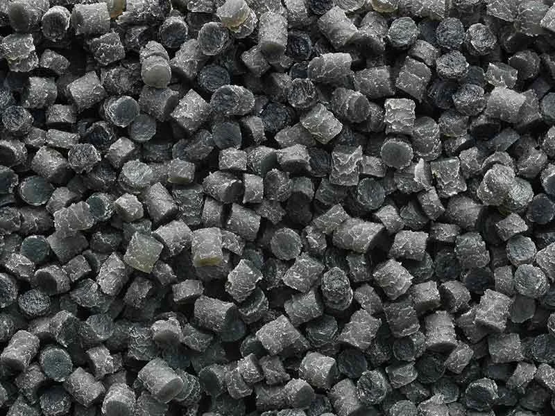 Small, black-grey pellets from a treatment process for rubber compounds
