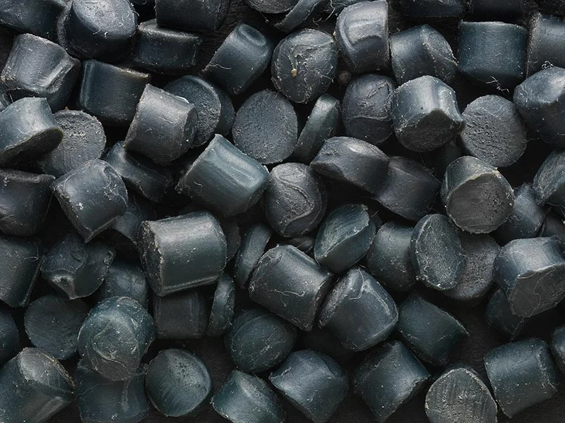 Black pellets from a treatment process for rubber compounds