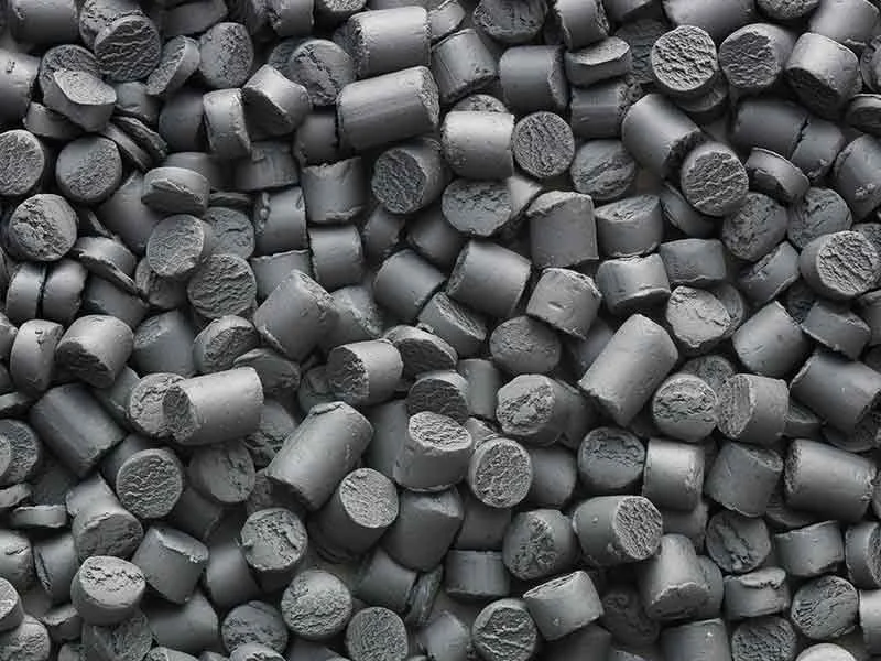 Dark-grey raw mass chunks are manufactured from polyamide (PA) using compounding technology