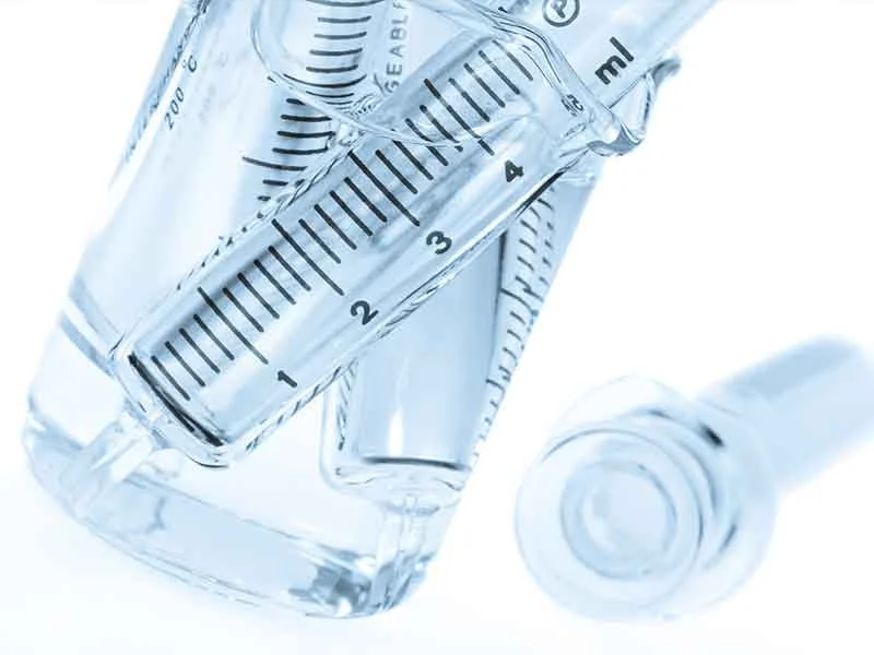 Injection molds in beakers as an example of rigid PVC compounding