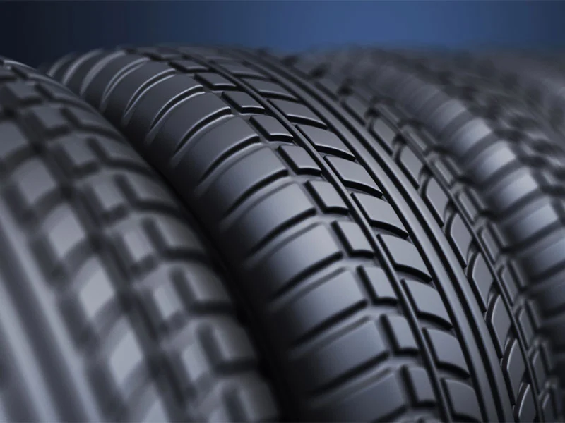 Black car tyres manufactured from rubber compounds.